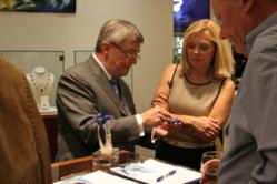 Pieter Andries shows jewelry design to Bob Jones President Debra Edmondson and Southlake Parks President John Slocum